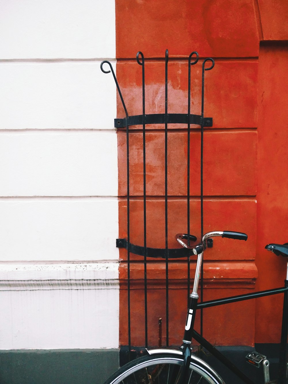 black bike beside wall