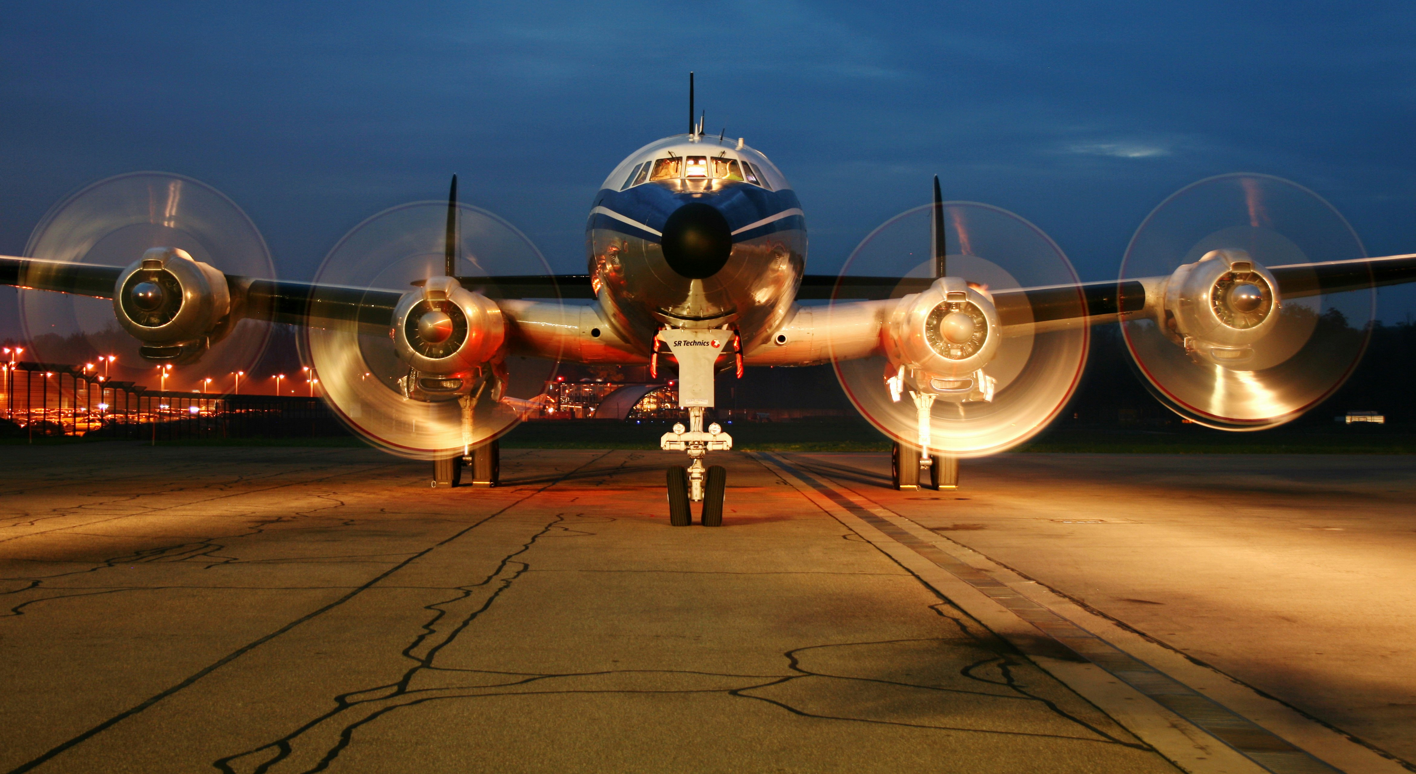 Especially for this photograph we postponed the monthly engine test to the end of the day.
We used three “follow me cars” to light up the propellers of this iconic aircraft. After the crash of a Junkers JU-52 aircraft in the Alps, the Civil Aviation Authority requested repairs and modifications of the Connie that would cost around CHF 20 Million. The Owners decided to sell the Connie to Germany. It will be taken to Bremgarten, Germany in the next few weeks. The new owner plans to repair the plane to former glory and take the skies again.