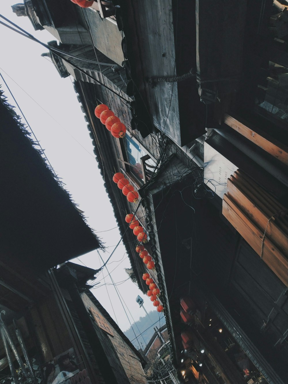 low angle photo of houses with lanterns