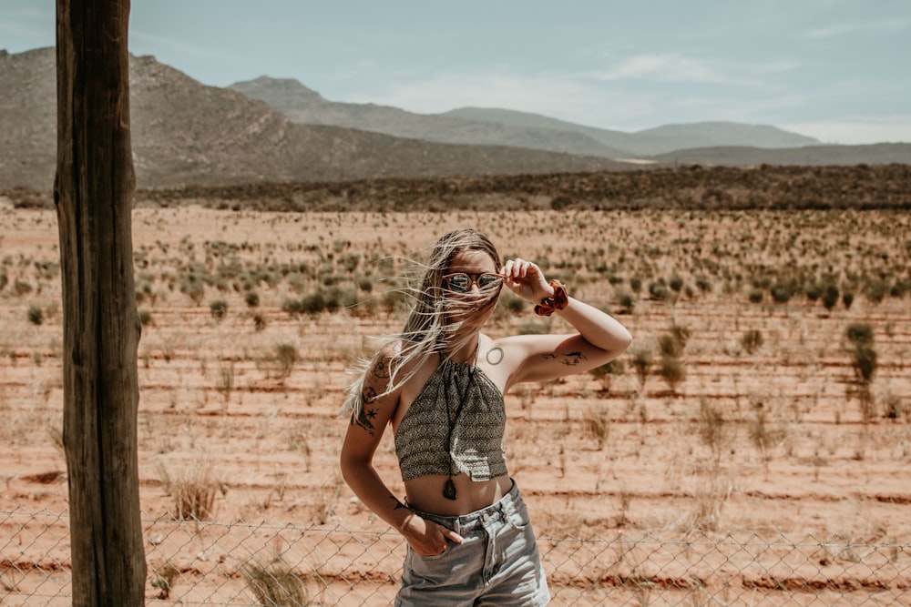 woman wearing gray top taking pose