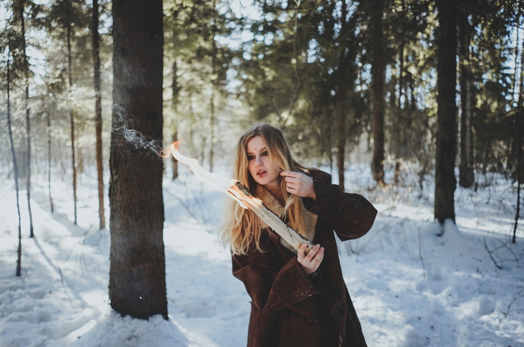 woman holding stick with fire