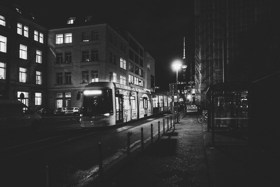 black and white photography of city and cars at night