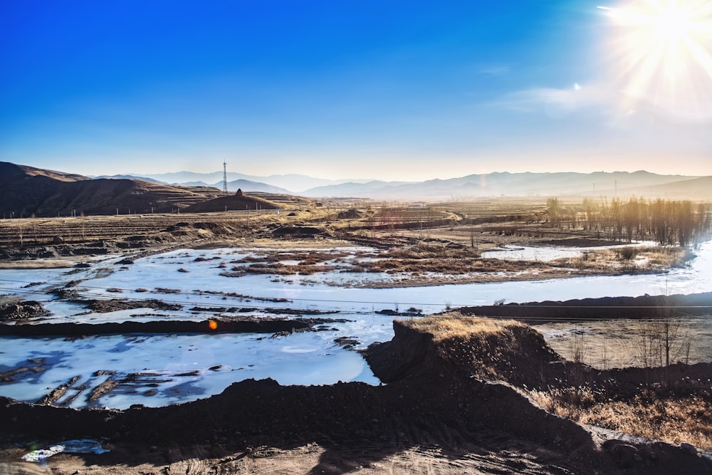 landscape photography of farm road under clear blue sky