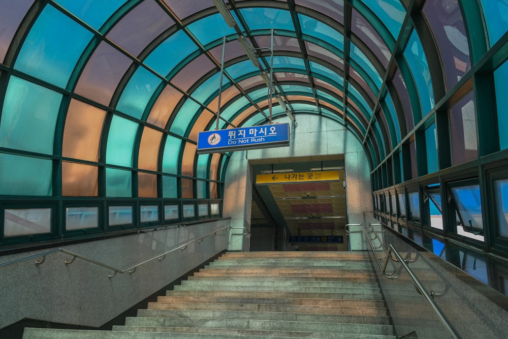 concrete stair under blue and gray dome ceiling