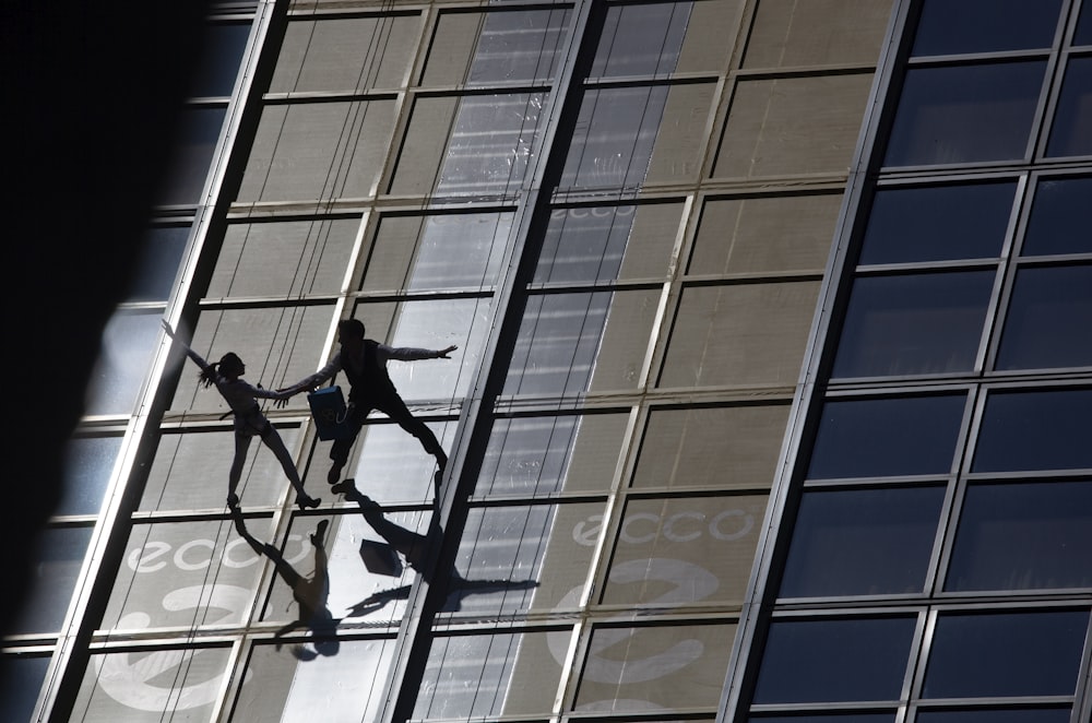 couple dancing on top of glass paneled building rooftop