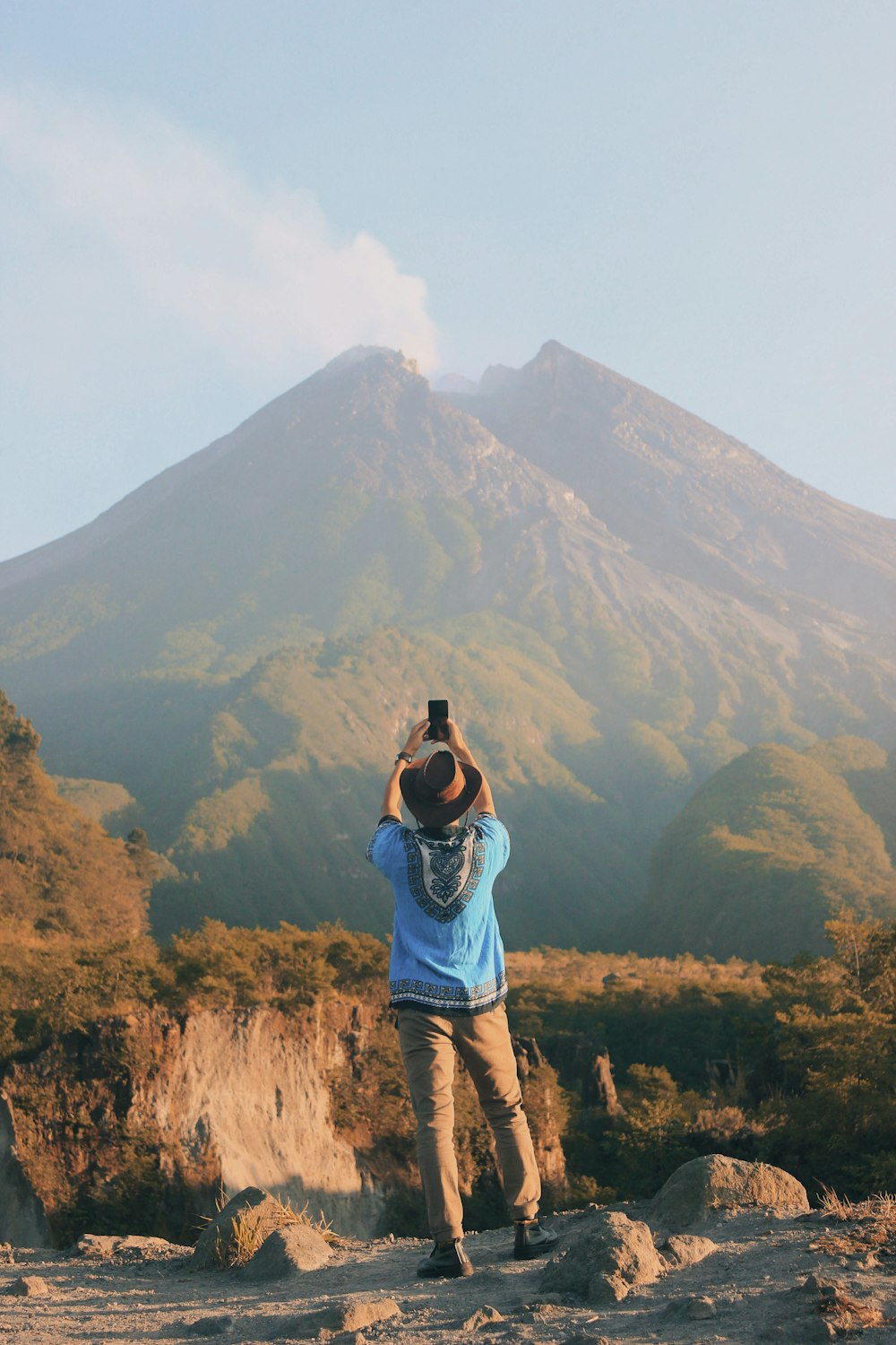 man taking photo of mountain