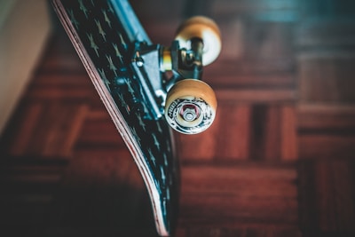 Close-up of colorful skateboard wheels on a wooden floor.