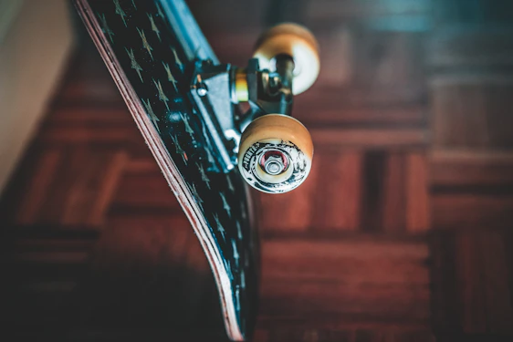 Close-up of a skateboard bearing spinning rapidly with urban graffiti in the background