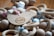 A wooden bird-shaped ornament with engraved text and decorative motifs is surrounded by an assortment of wooden rings and multicolored beads in soft pastel shades. The beads are geometric in shape, including spheres and hexagons, strung together with cords.