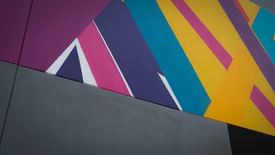 a multicolored abstract painting on the side of a building