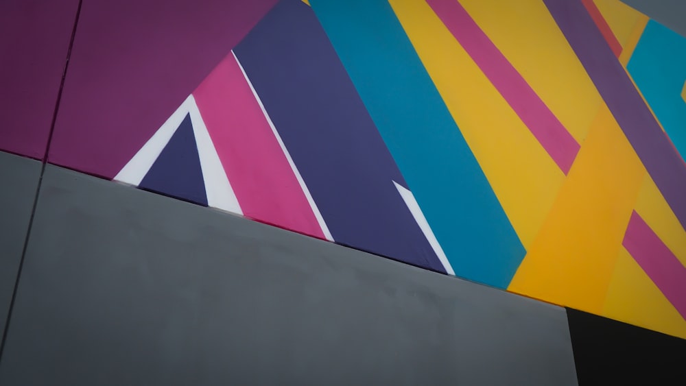 a multicolored abstract painting on the side of a building