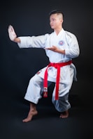man standing wearing white karate gi