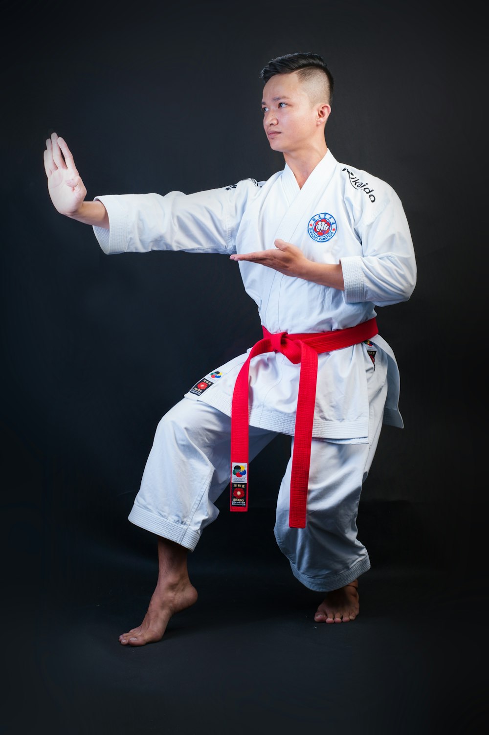 man standing wearing white karate gi