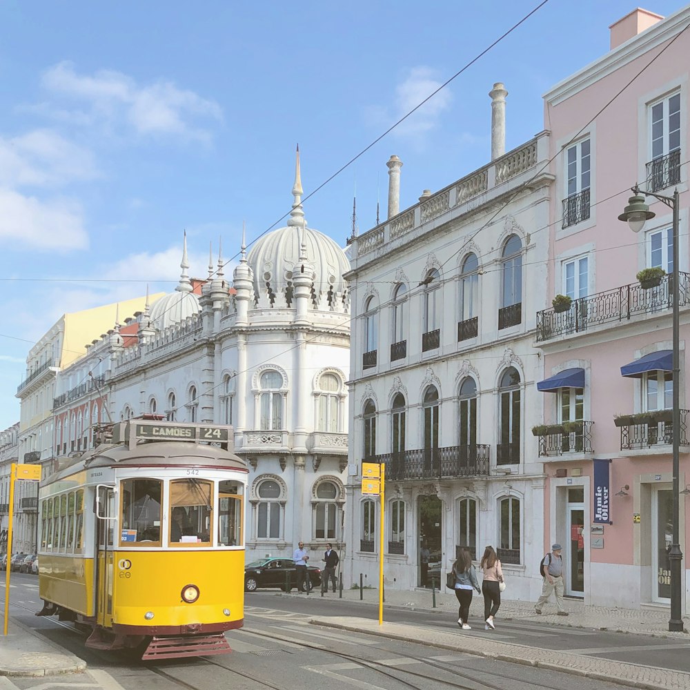 yellow tram on road during daytime