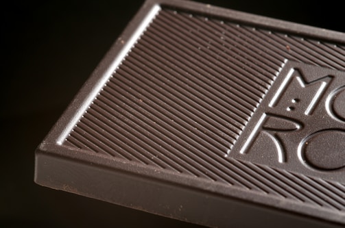 Close-up of rich, handcrafted chocolate bars with visible cacao nibs.