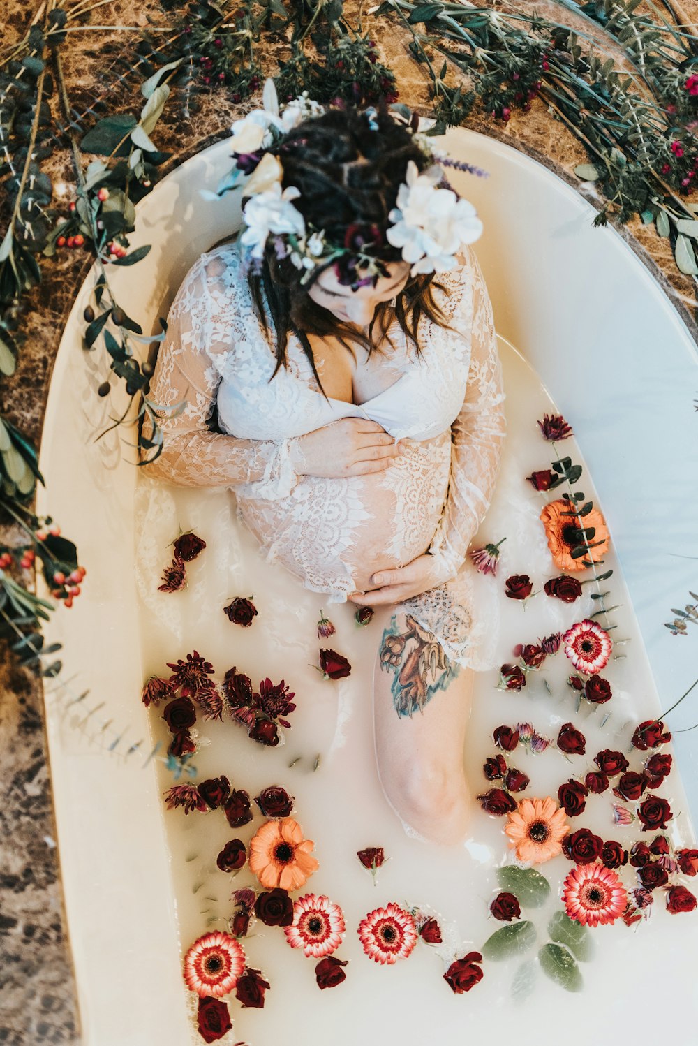 pregnant woman on bathtub covered with white liquid