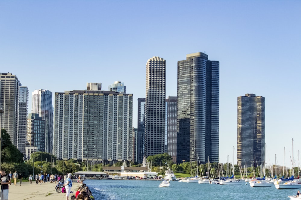 people beside beach near buildings