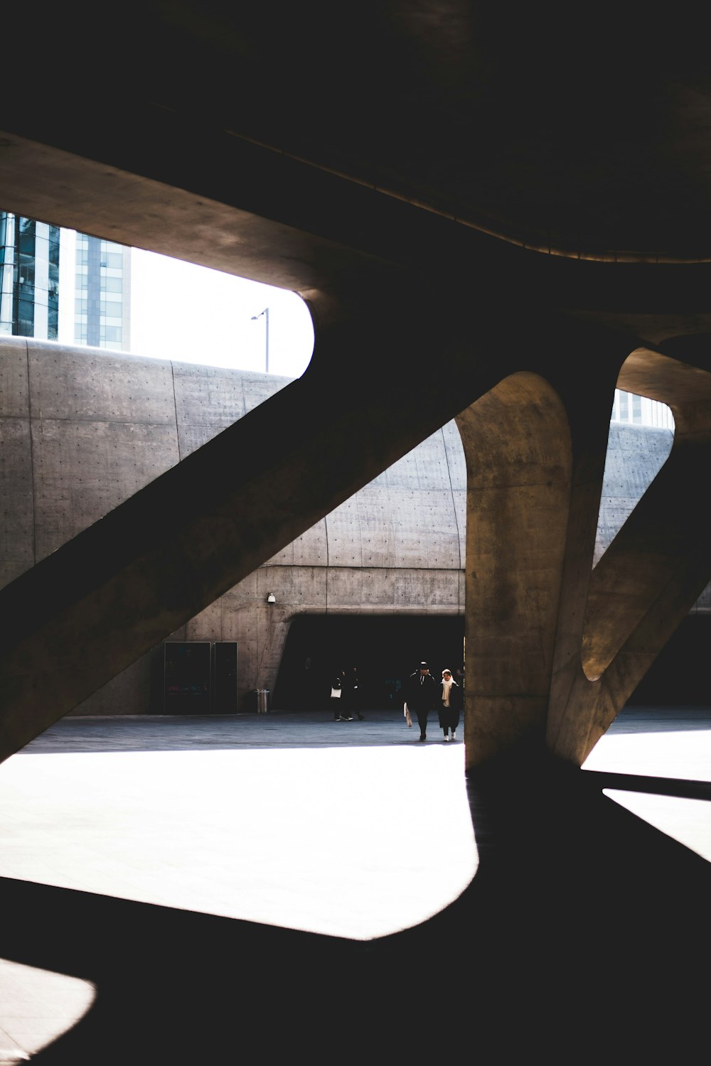 a couple of people standing under a large structure