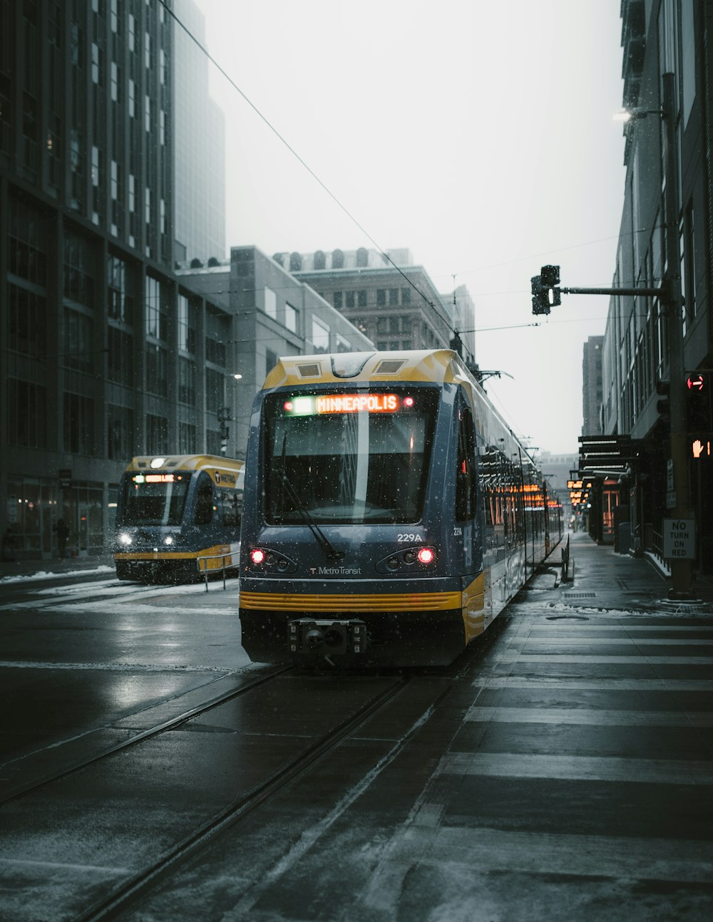 yellow and gray bus on street during cloudy daytime