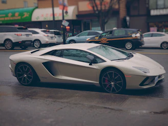 A sleek white Swift parked near a bustling city street in Bilaspur.