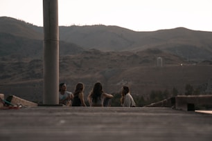 people sitting over looking mountains