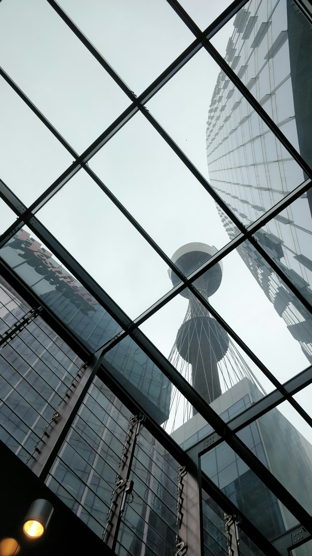a view of a tall building through a glass window