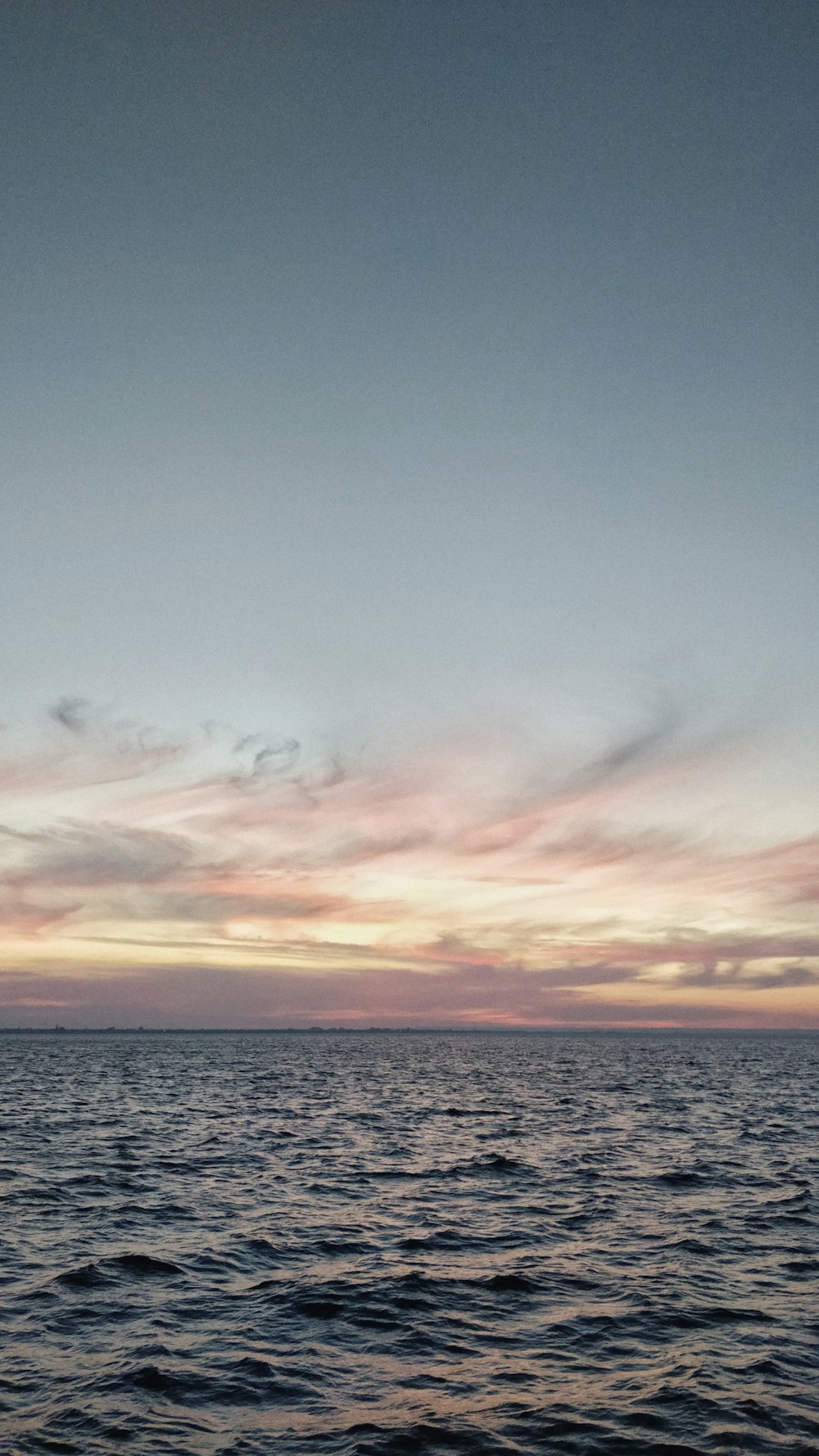 calm sea under clear blue sky during daytime