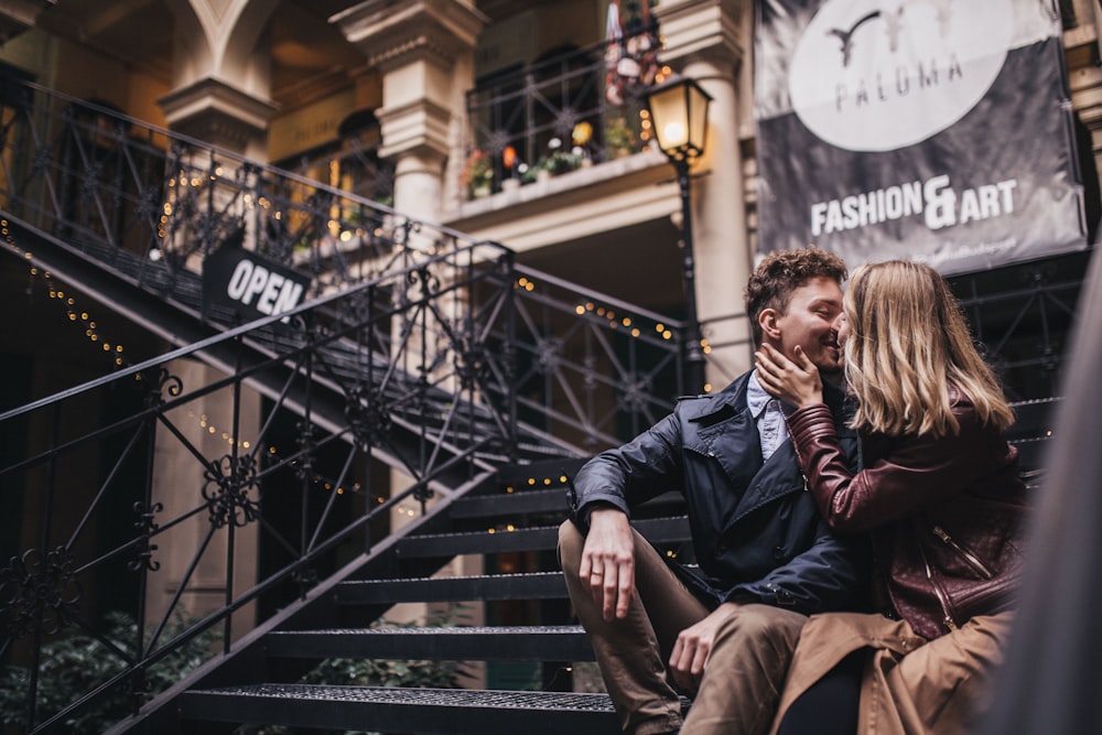 woman and man sitting on stairs