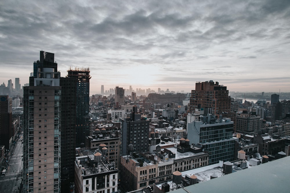 aerial photo of city buildings under cloudy sky