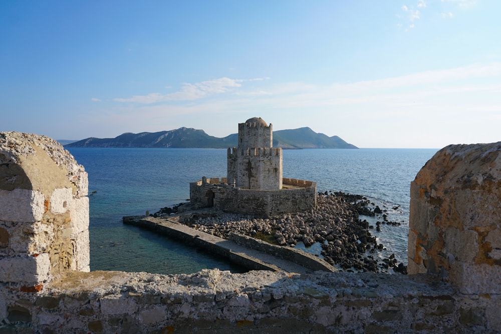 gray concrete building surrounded by sea during daytime