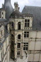 Architect examining detailed stonework in a historic European villa.