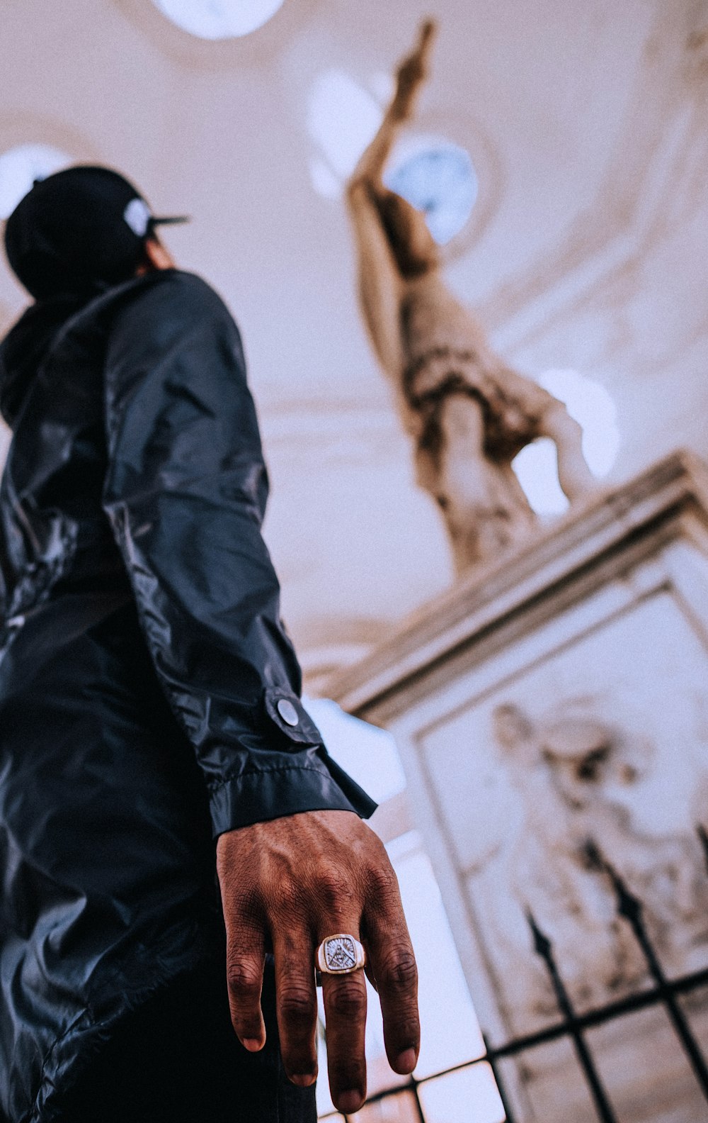 shallow focus photo of person looking at statue