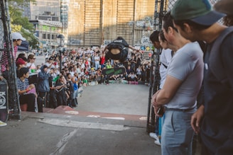 A crowd enjoying a skateboard competition with banners and excitement.