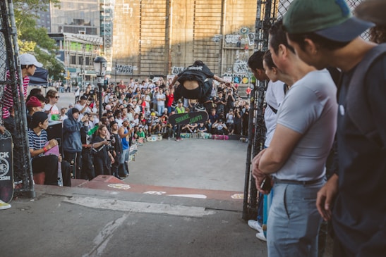 A crowd enjoying a skateboard competition with banners and excitement.