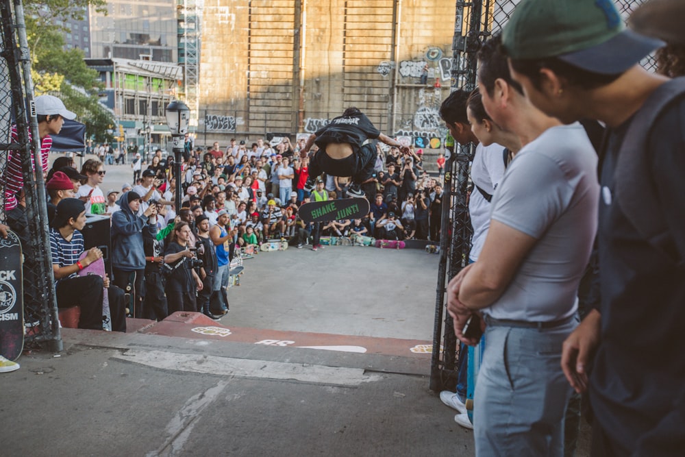 group of people watching skateboard trick