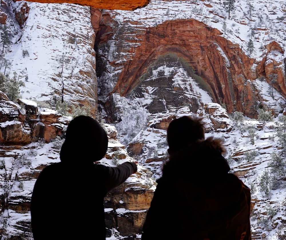 two persons pointing mountain