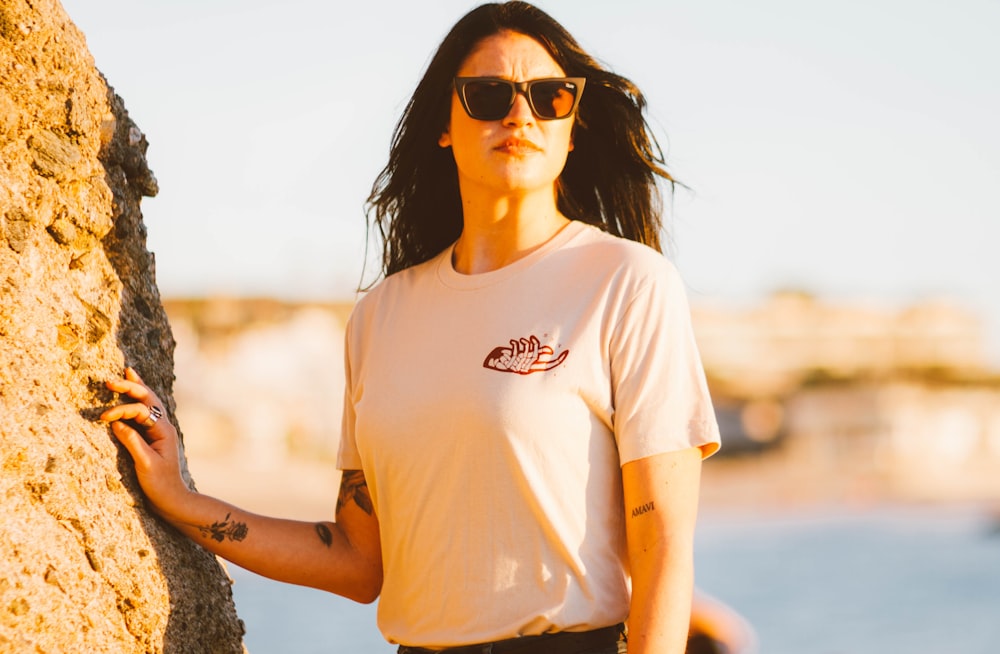 woman in white T-shirt holds rock