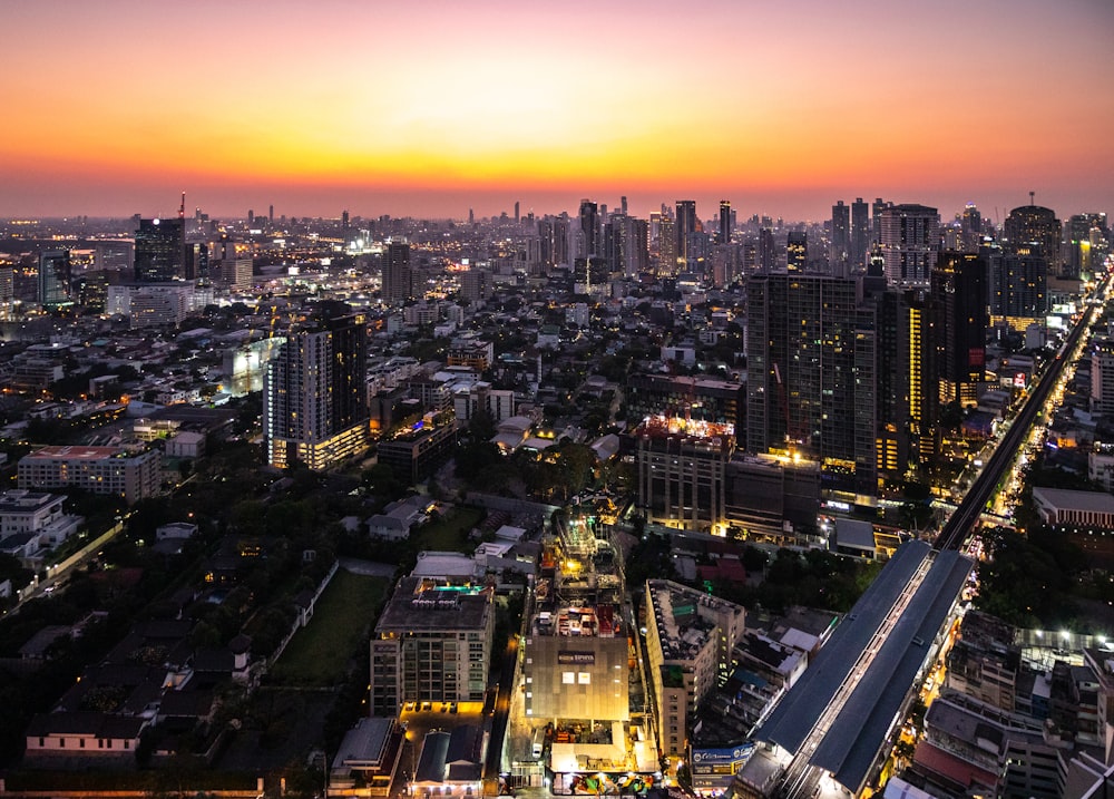 aerial photography of buildings and cars on road during sunset