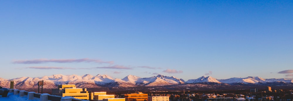 aerial photo of houses and buildings and mountain range under blue sky during daytime