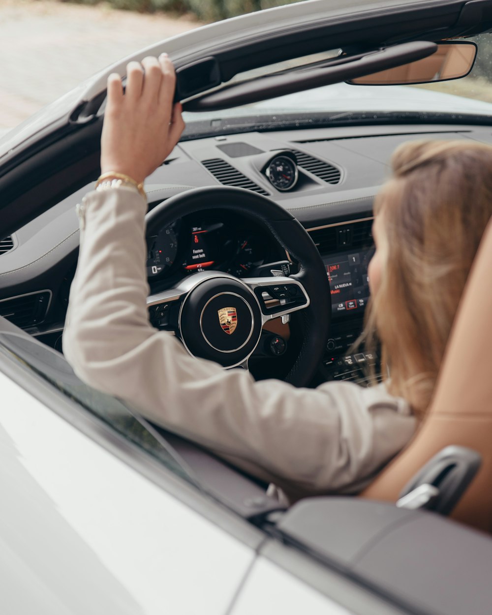 woman driving Cadillac vehicle