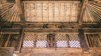 Close-up of handcrafted wooden beams showing the fine detail and care typical of Amish construction.