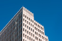 A completed high-rise building showcasing clean lines and architectural precision under a clear sky.