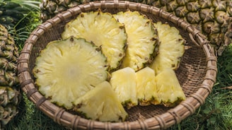 sliced pineapples served on brown basket