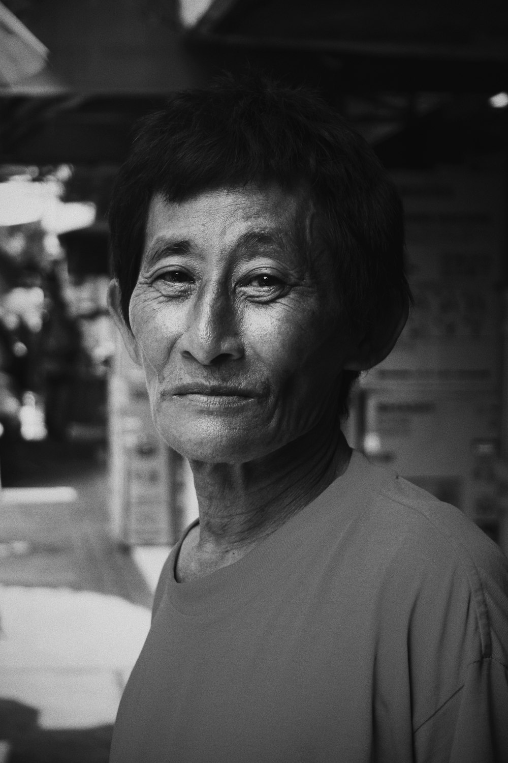 greyscale photo of smiling man wearing crew-neck shirt