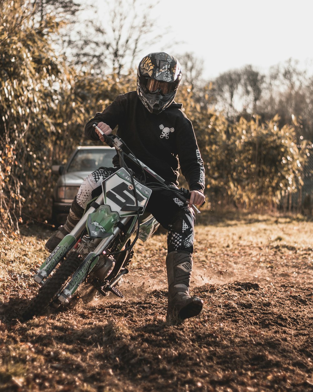 a man riding a dirt bike on top of a dirt field