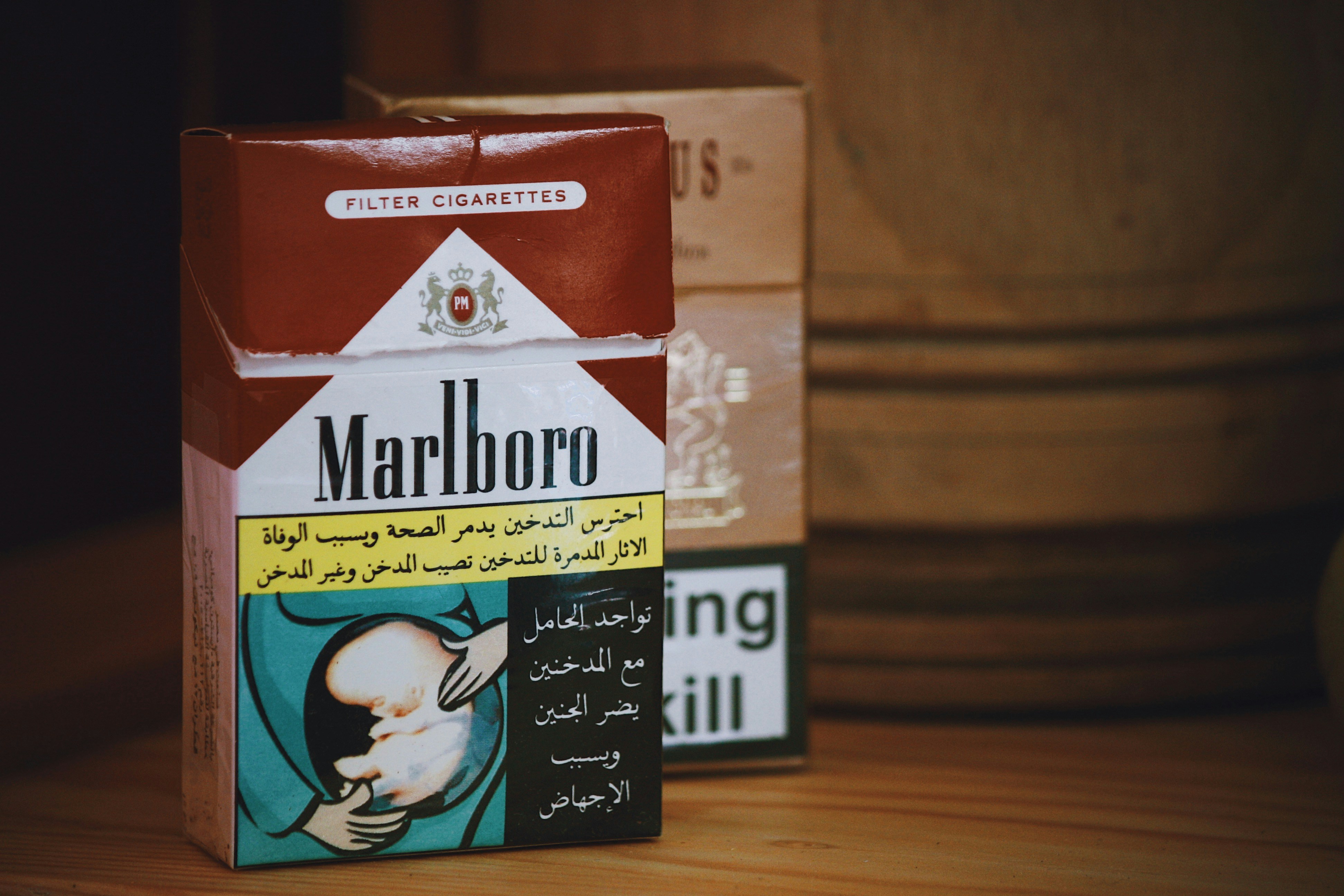 Marlboro fliptop cigarette box on wooden surface photo Free Box