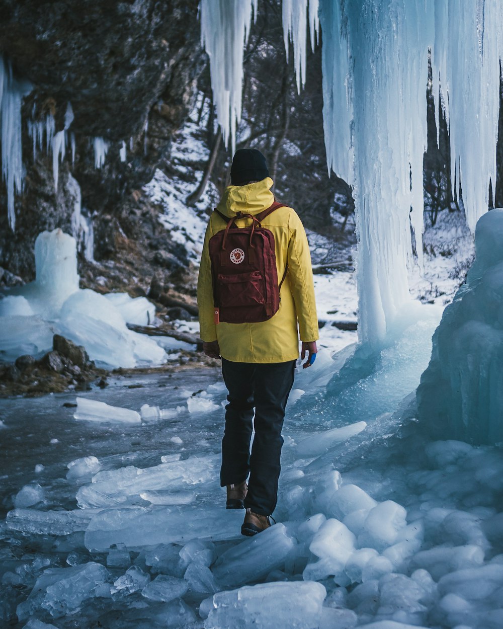 man carrying red backpack