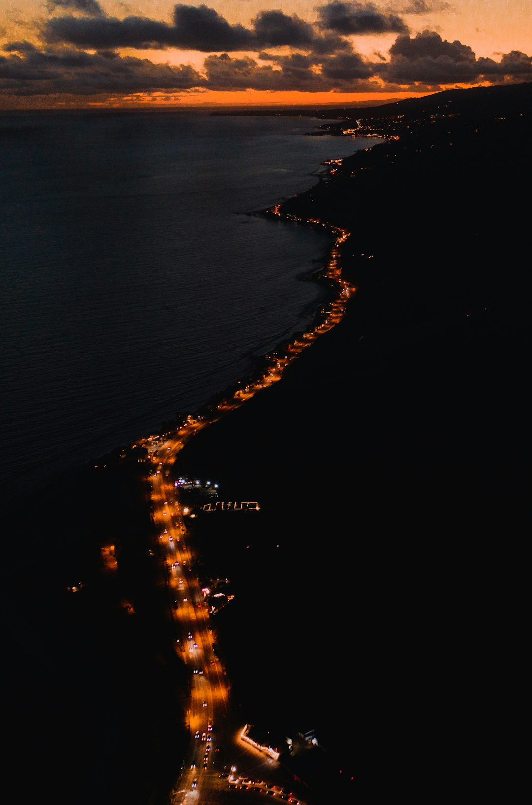 aerial photography of road beside water