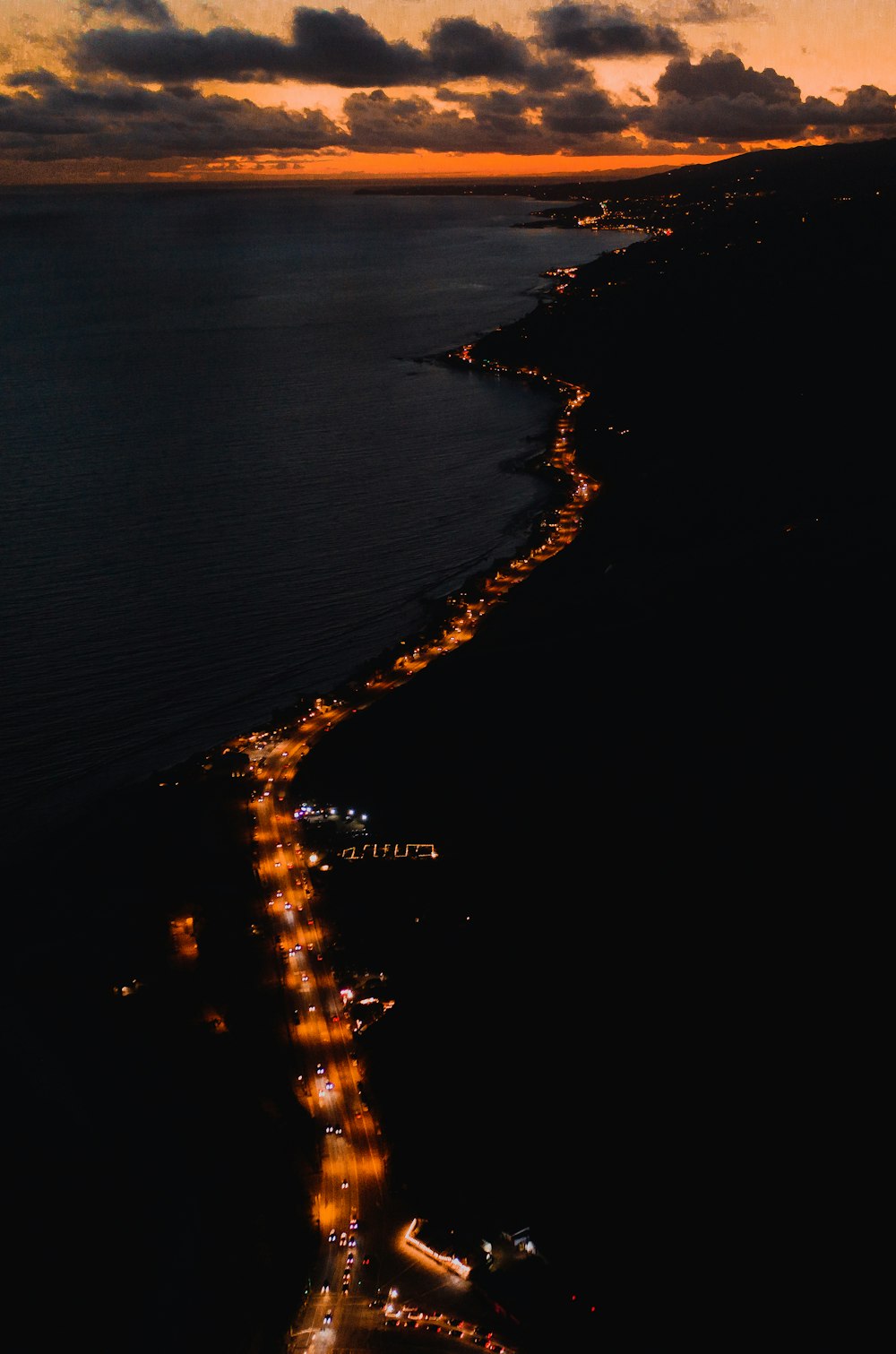 aerial photography of road beside water