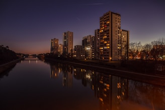 brown concrete building beside water
